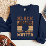 a black man's matter sweatshirt next to a pair of sneakers
