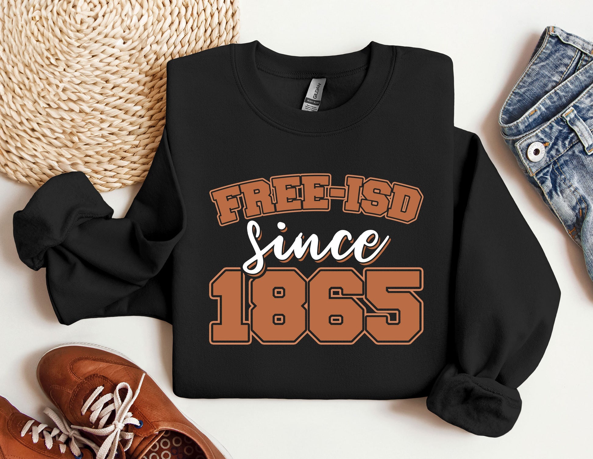 a black sweatshirt that says free - isd since 1965 next to a pair of