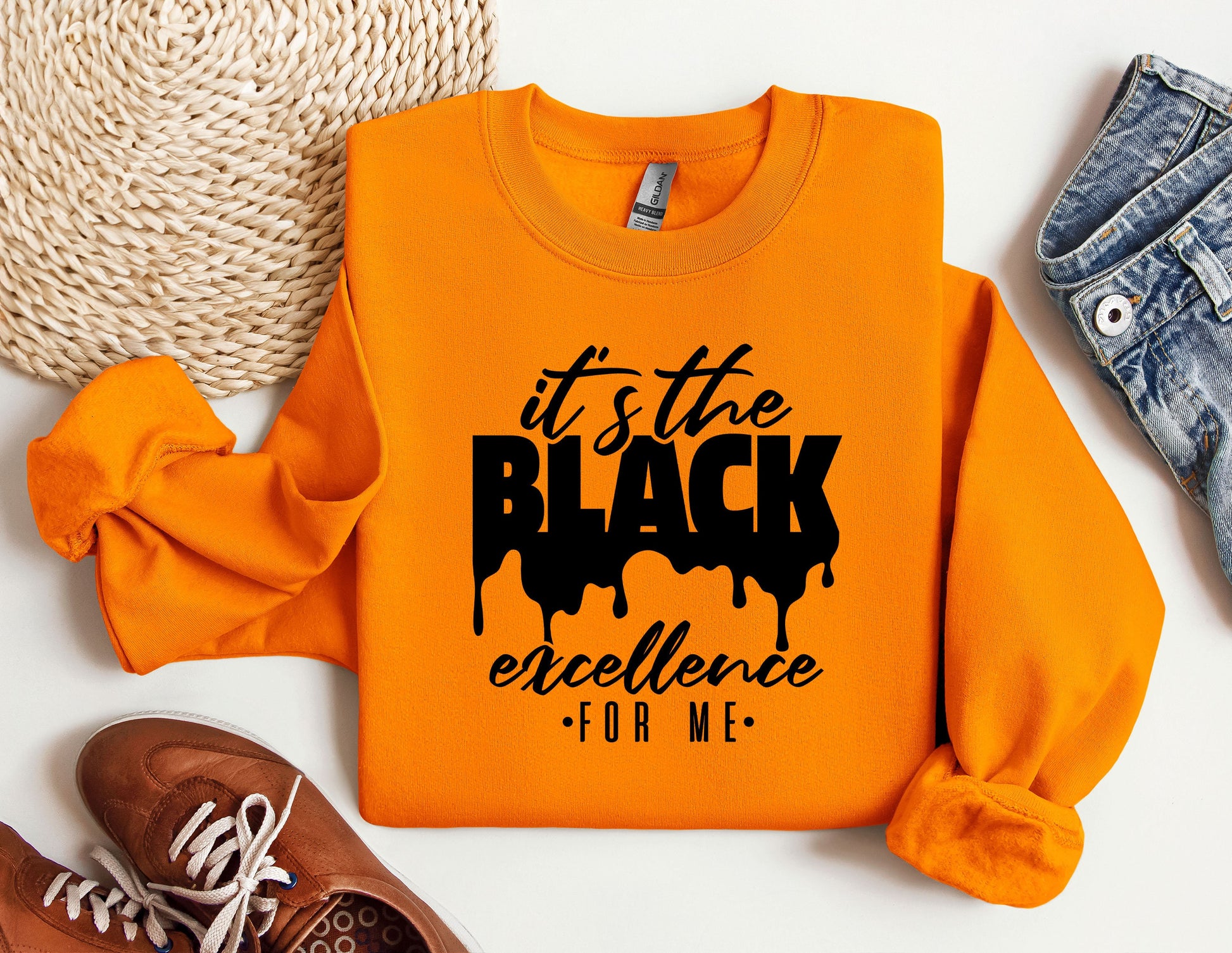 an orange sweatshirt with the words it&#39;s the black excellence on it