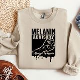 a sweatshirt with a fist drawn on it next to a pair of shoes