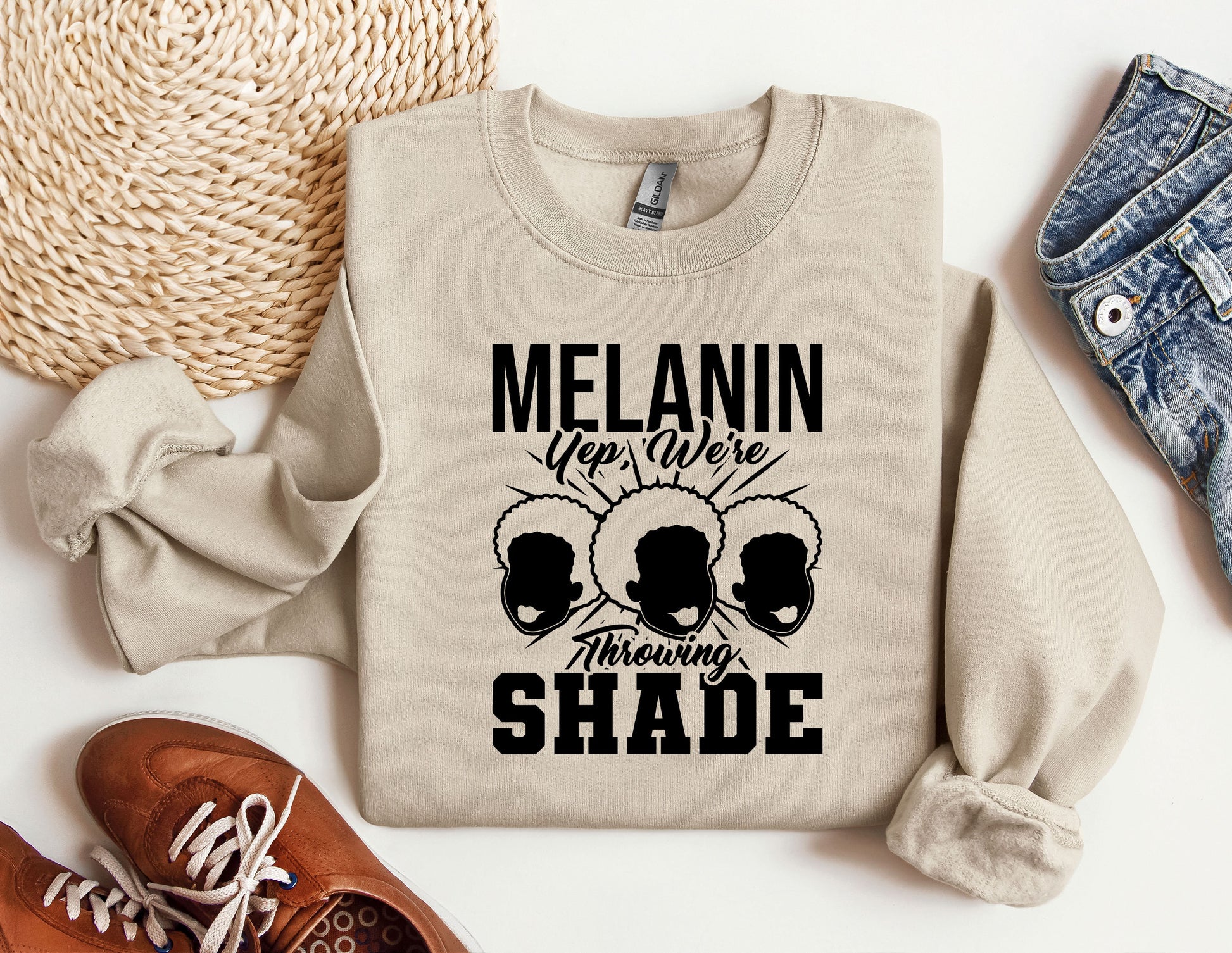 a sweatshirt with the words melanin on it next to a pair of shoes