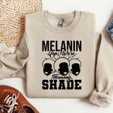 a sweatshirt with the words melanin on it next to a pair of shoes