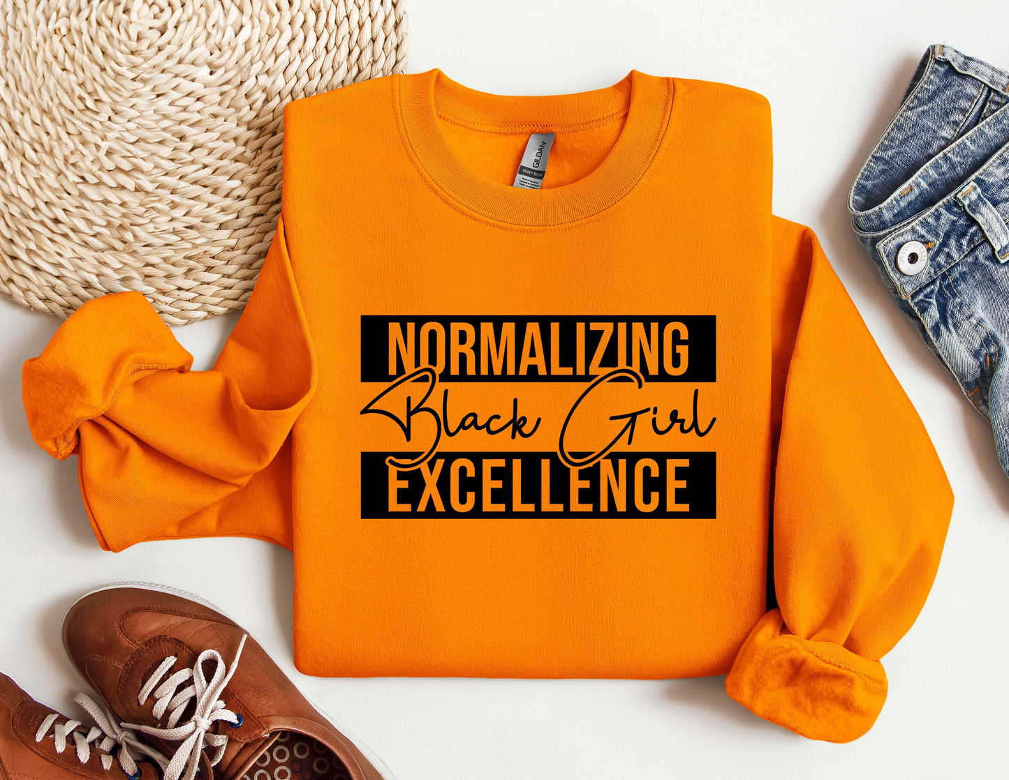 an orange shirt that says normalizing black girl excellence