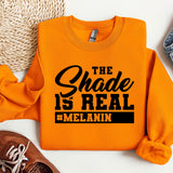 an orange sweatshirt with the words the shade is real on it