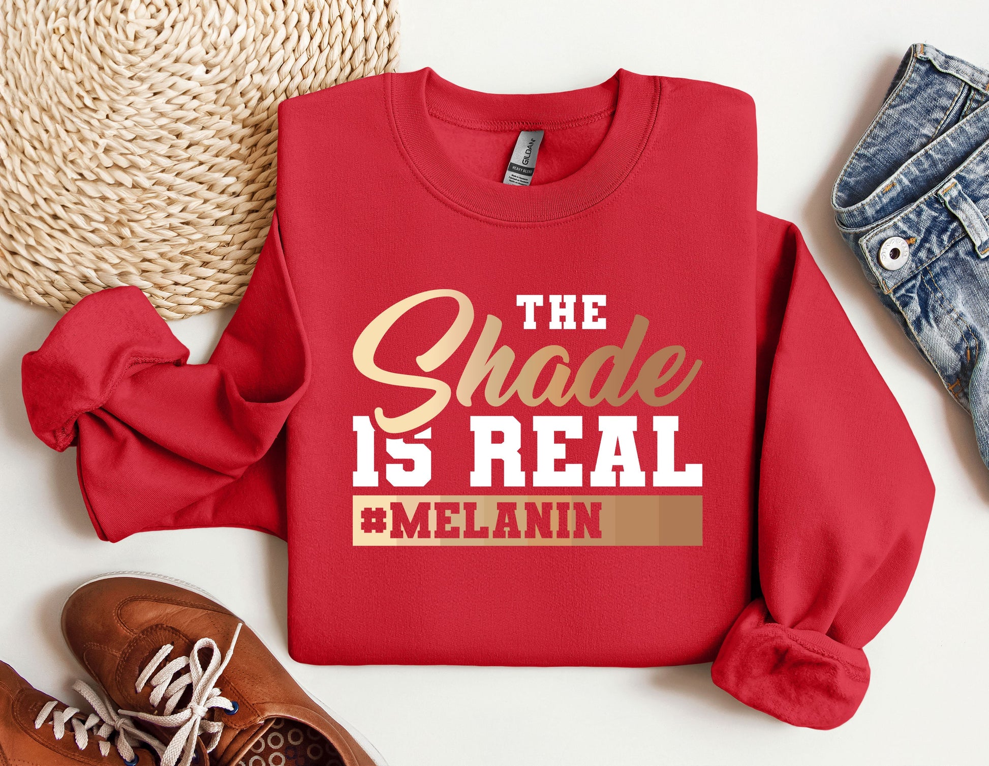 a red sweatshirt with the words the shade is real and melanin on it