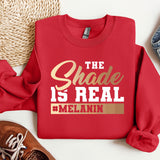 a red sweatshirt with the words the shade is real and melanin on it