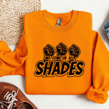 a pair of shoes and a sweatshirt on a white surface