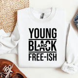 a young and black shirt next to a pair of shoes