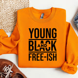 a young and black shirt next to a pair of shoes