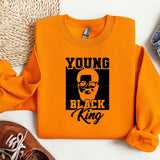 a young black king shirt next to a pair of sneakers