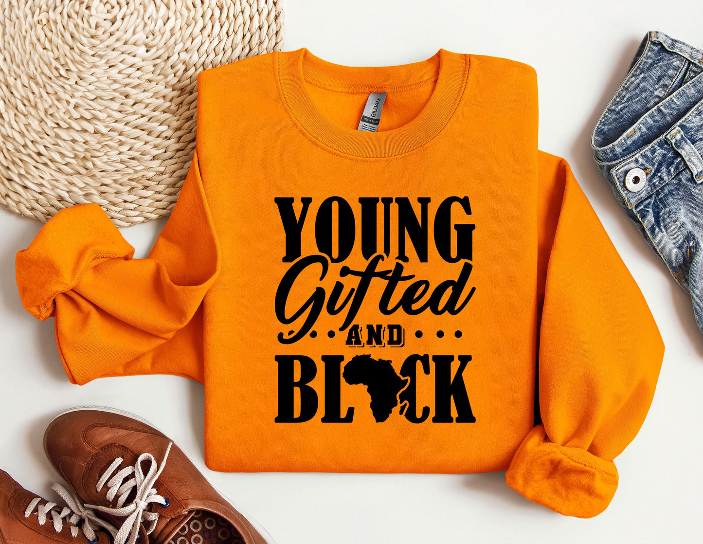 an orange shirt that says young, gifted and black