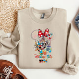 a mickey mouse sweatshirt with a pair of shoes next to it