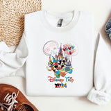 a white shirt with mickey mouse on it next to a pair of shoes