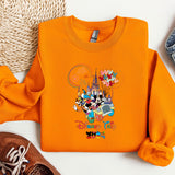 an orange shirt with mickey mouse on it