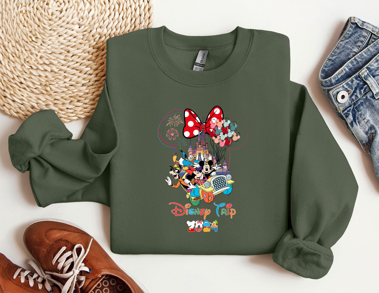 a green sweatshirt with mickey mouse on it