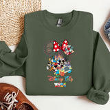 a green sweatshirt with mickey mouse on it