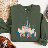 a green sweatshirt with disneyland castle on it