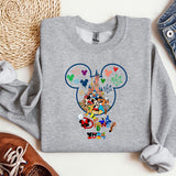 a gray sweatshirt with mickey mouse on it