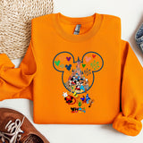 an orange shirt with mickey mouse on it