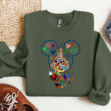 a green sweatshirt with a mickey mouse design on it