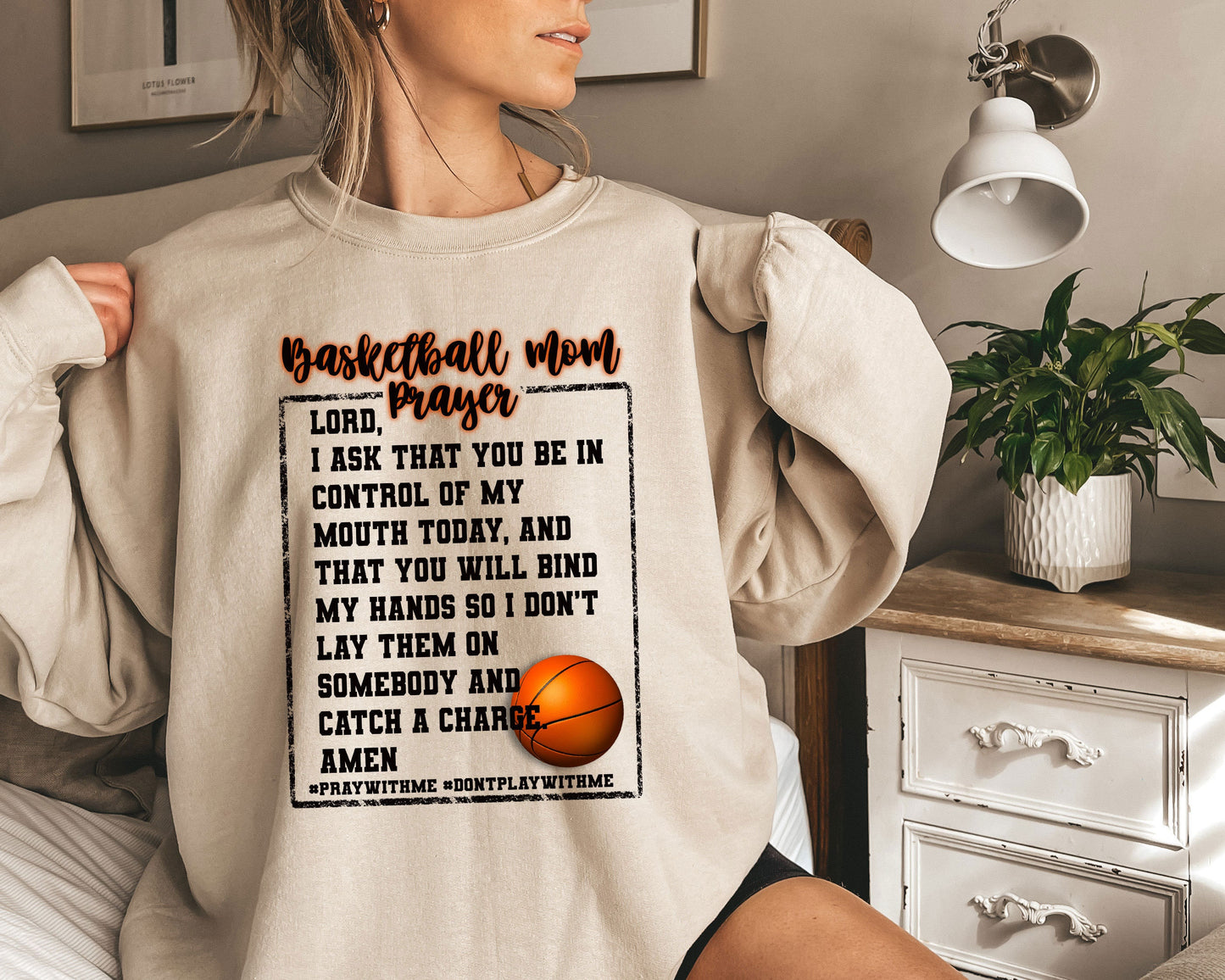 a woman wearing a sweatshirt with a basketball on it