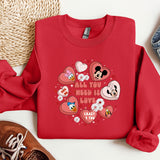 a red sweatshirt with mickey mouses and hearts on it