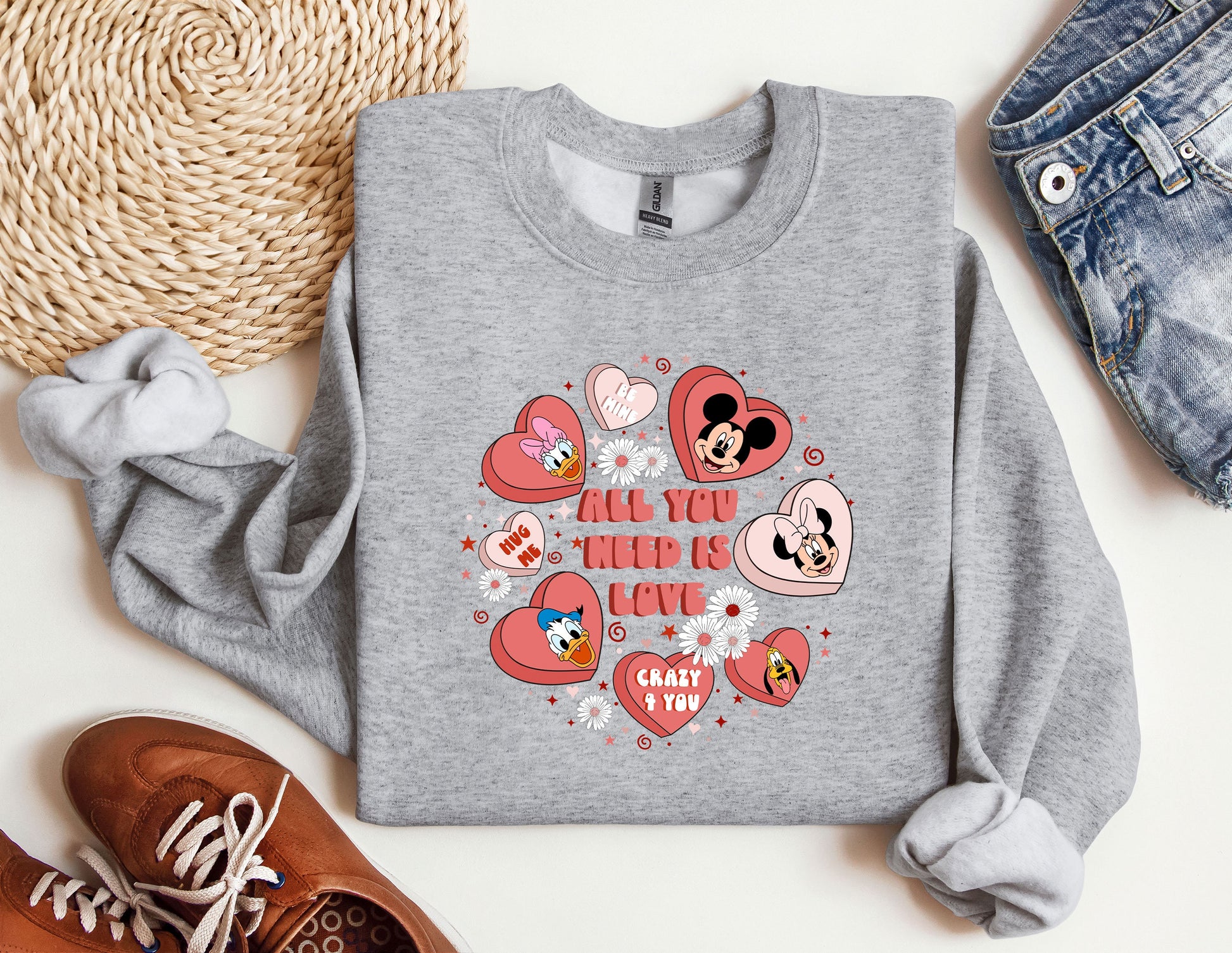 a gray sweatshirt with hearts and mickey mouses all you need is love