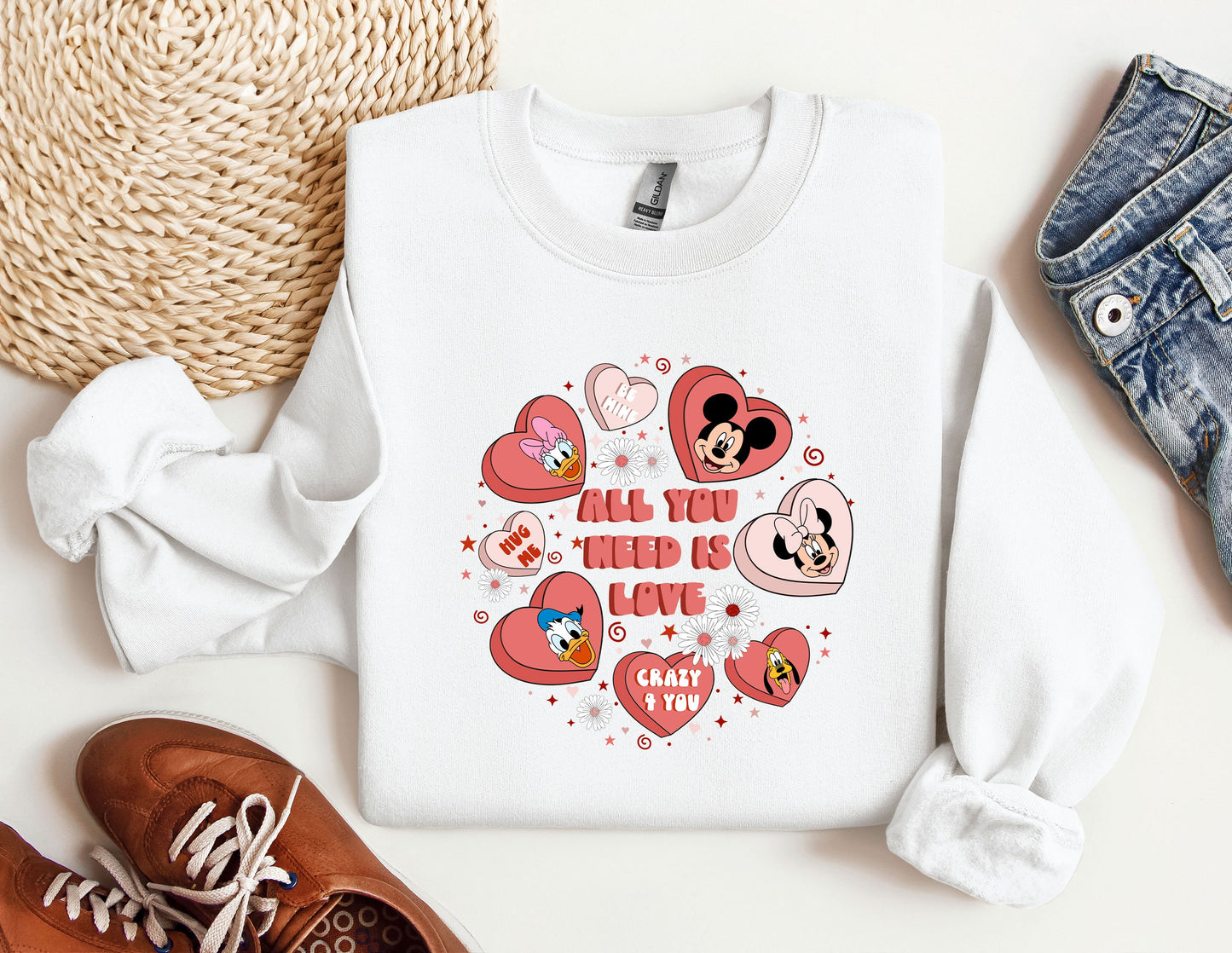 a white shirt with hearts and mickey mouses on it