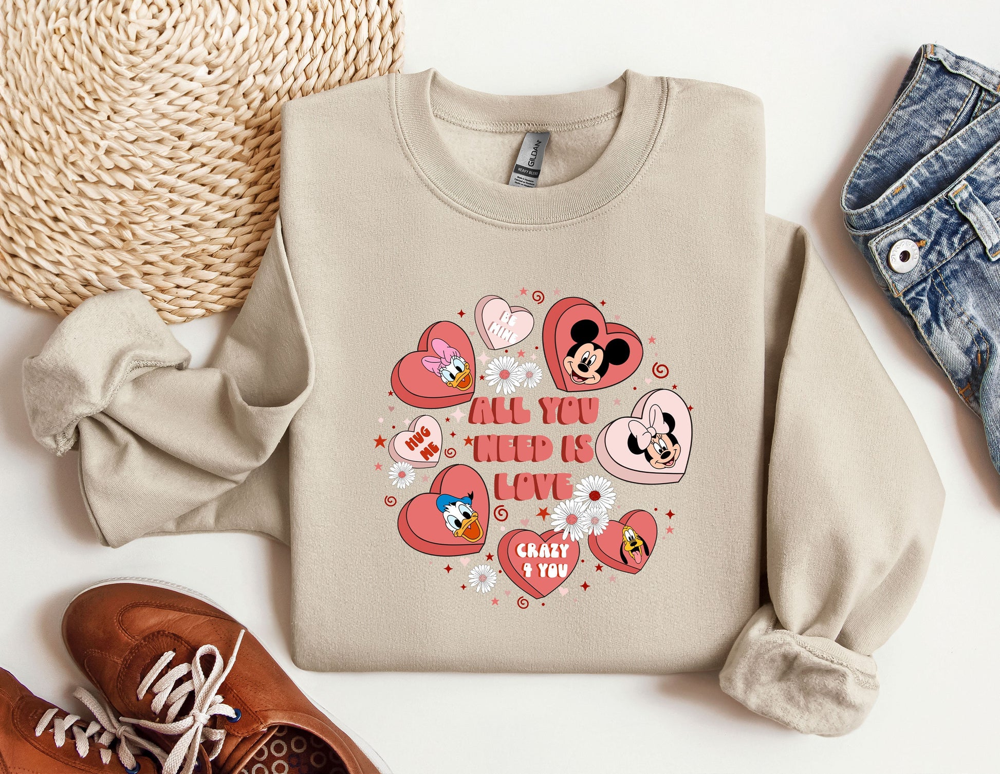 a sweater with hearts and mickey mouses on it