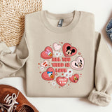 a sweater with hearts and mickey mouses on it