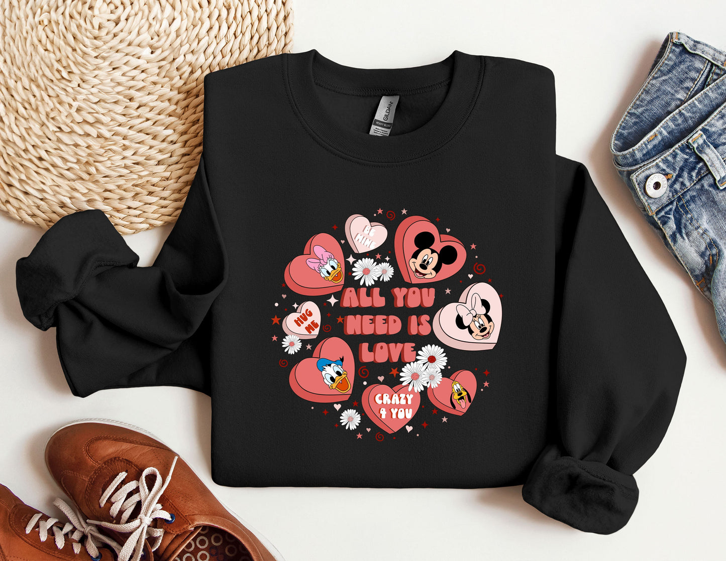 a black sweatshirt with hearts and mickey mouses on it