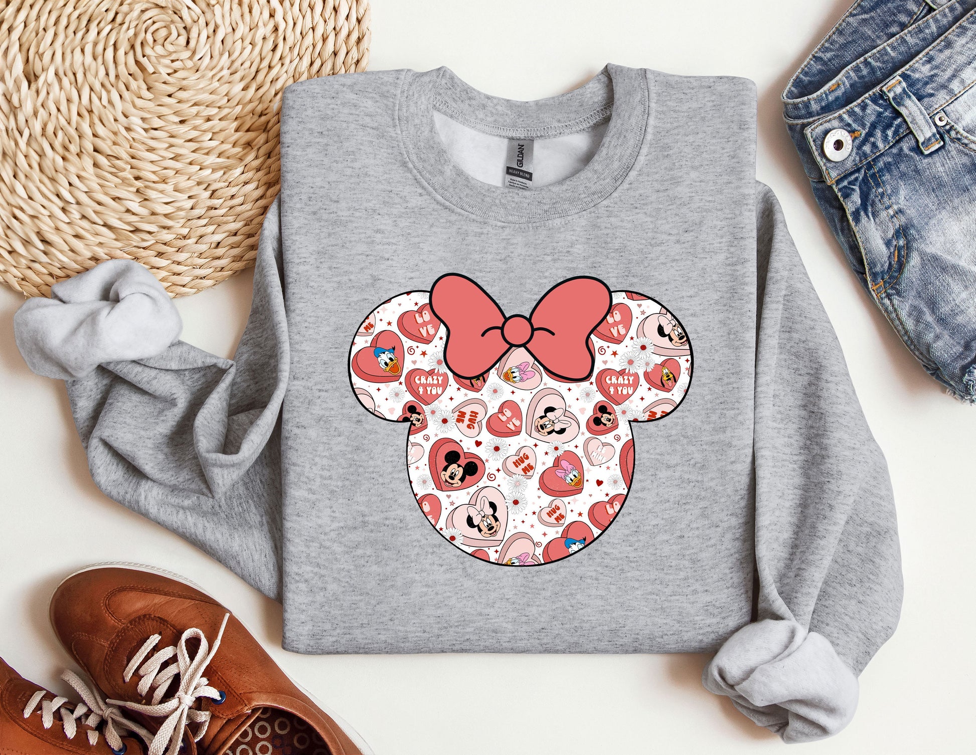 a gray sweatshirt with a red bow and hearts on it