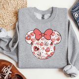 a gray sweatshirt with a red bow and hearts on it