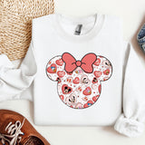 a white shirt with a red bow and hearts on it