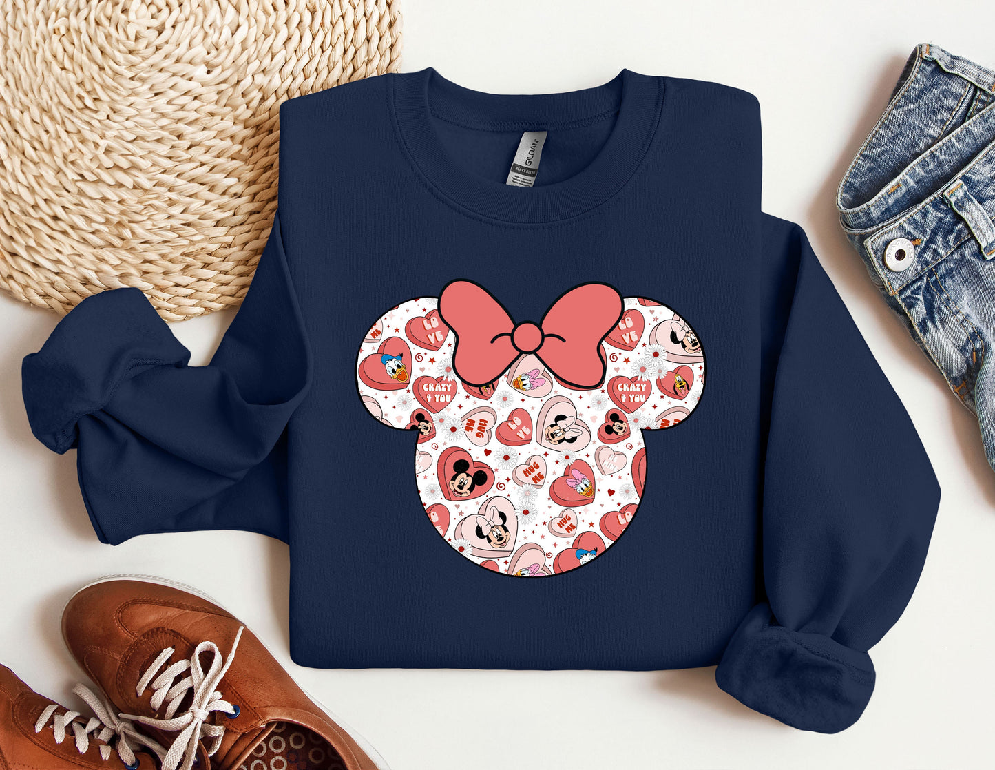 a blue sweatshirt with a red bow and hearts on it