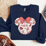 a blue sweatshirt with a red bow and hearts on it