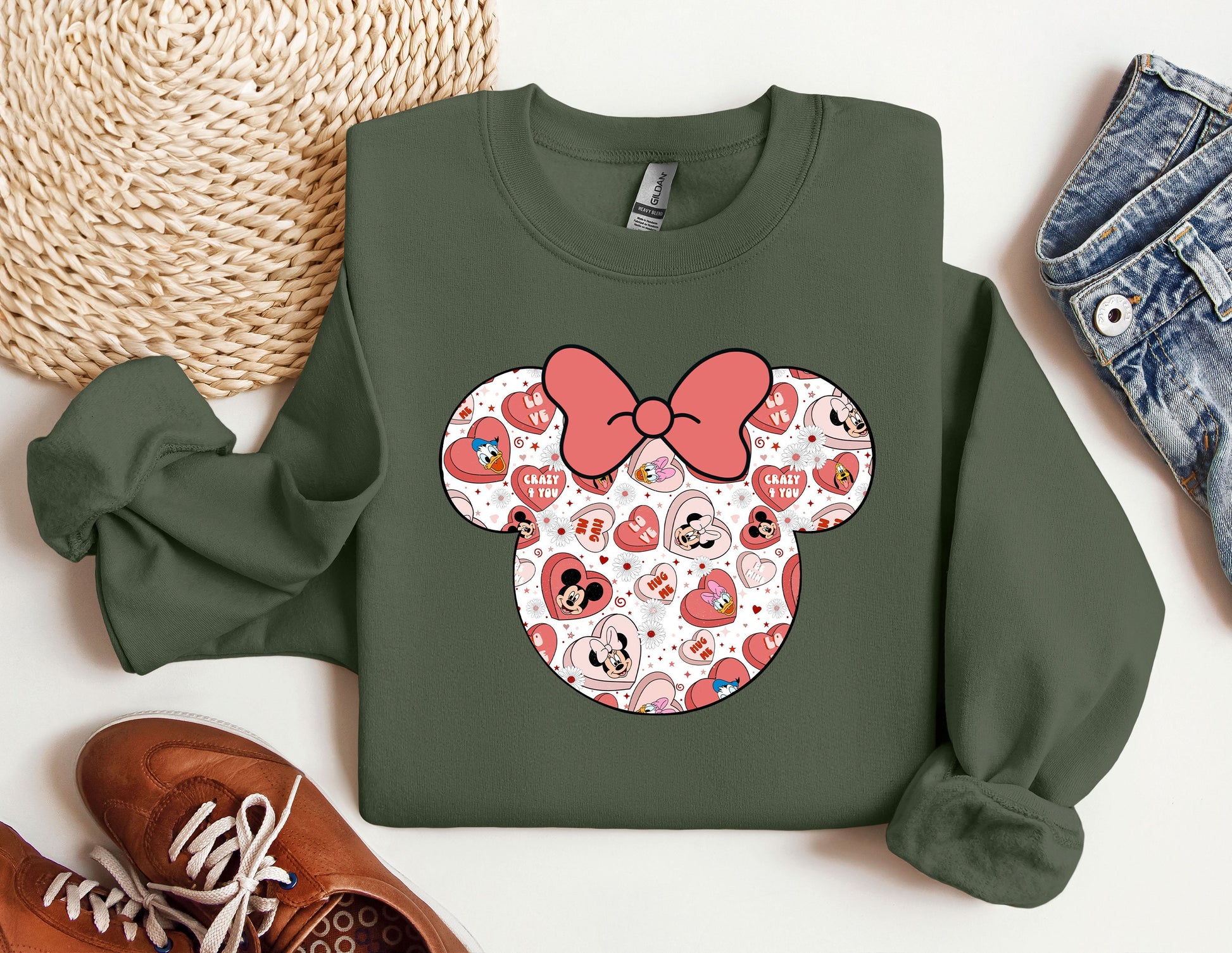 a green sweatshirt with a red bow and hearts on it