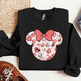 a black shirt with a red bow and hearts on it