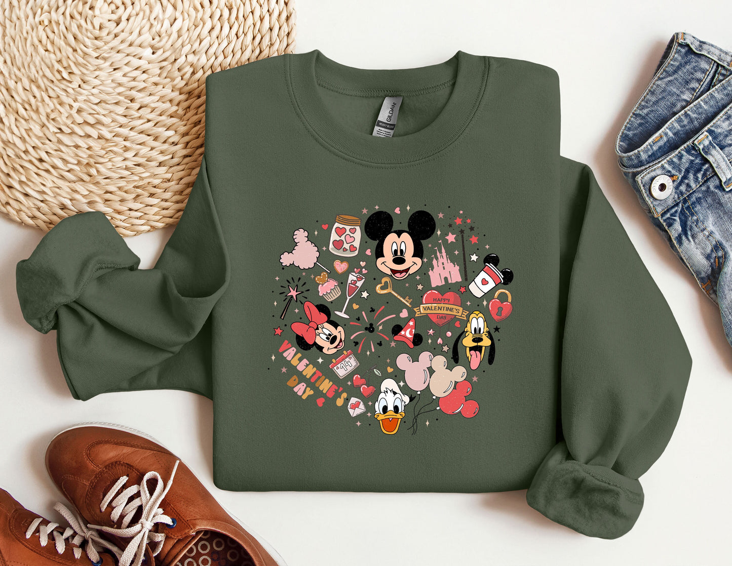 a green sweatshirt with a mickey mouse design on it