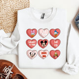 a white shirt with mickey mouse hearts on it