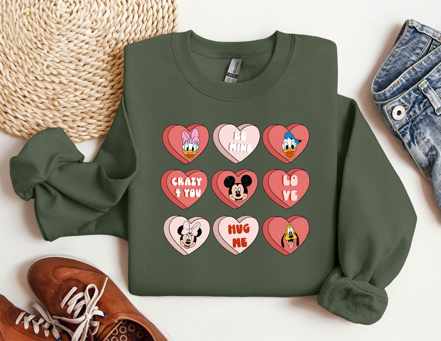 a green sweatshirt with hearts and mickey mouse faces