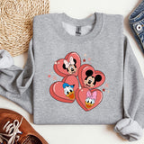 a pair of mickey and minnie mouse hearts on a sweatshirt