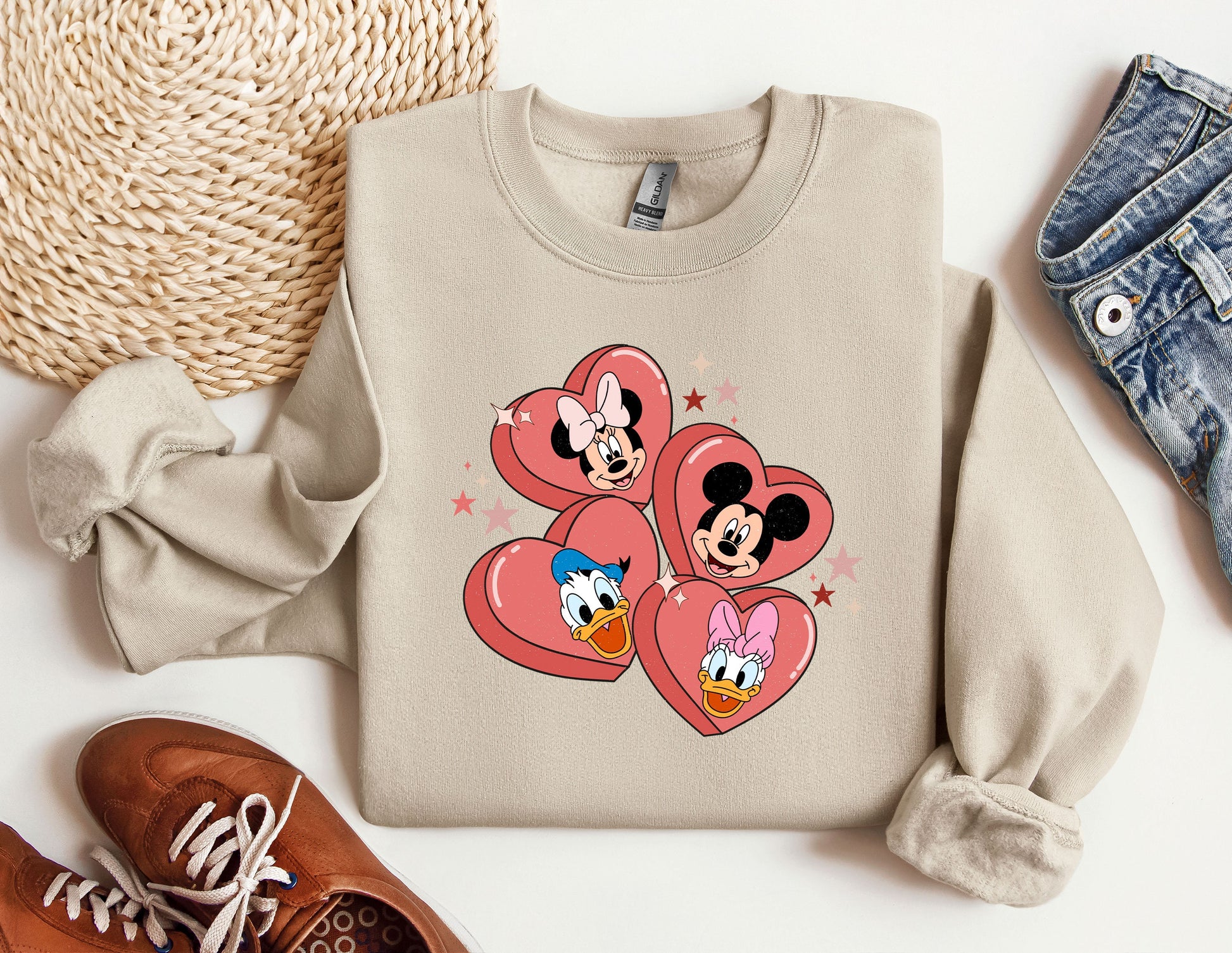 a pair of shoes and a sweater with mickey and minnie mouse on them