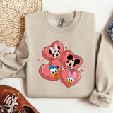 a pair of shoes and a sweater with mickey and minnie mouse on them