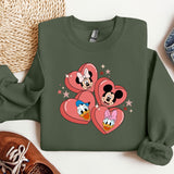a green sweatshirt with mickey and minnie hearts on it