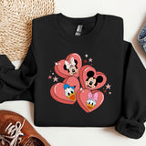 a pair of sneakers and a mickey mouse sweatshirt