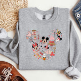 a mickey mouse shirt is laying next to a pair of shoes