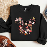 a black sweatshirt with a mickey mouse design on it
