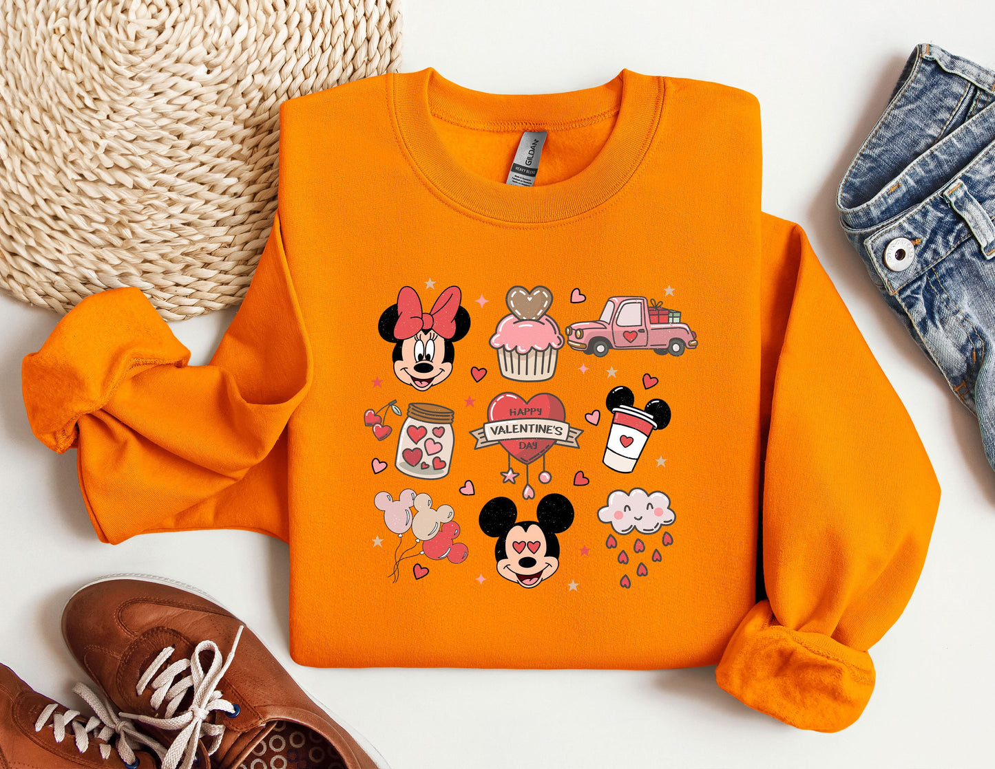 a pair of sneakers and a sweatshirt with mickey mouse on it