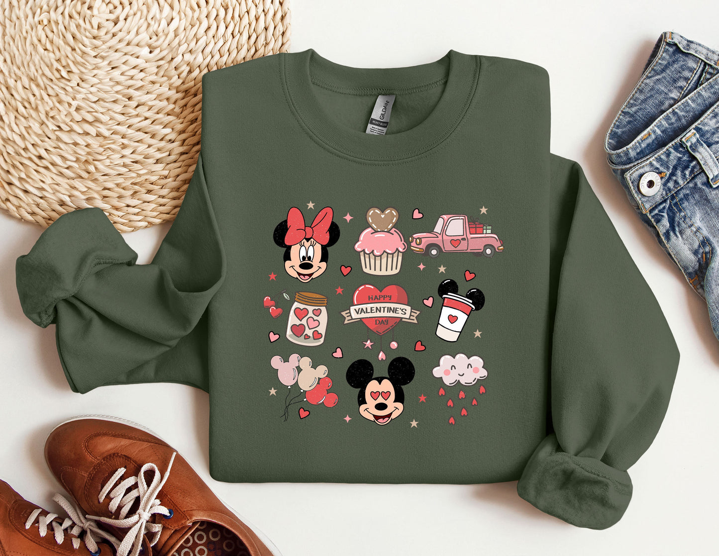 a green sweatshirt with mickey mouse and minnie mouse on it